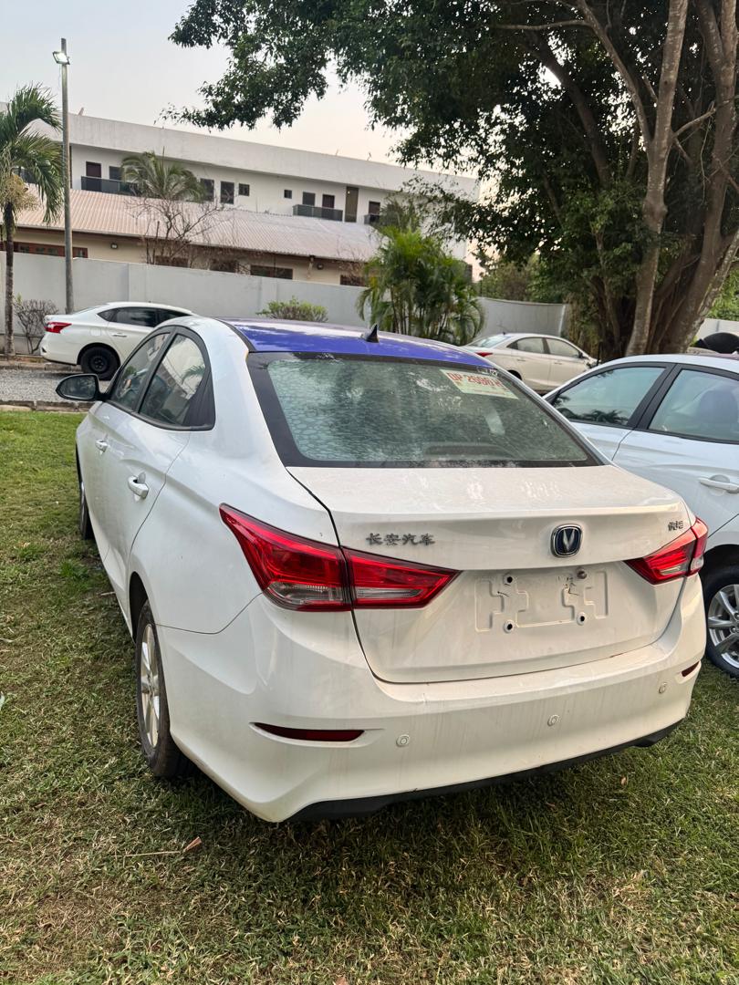 Electric commercial sedan staged at the depot, rear view